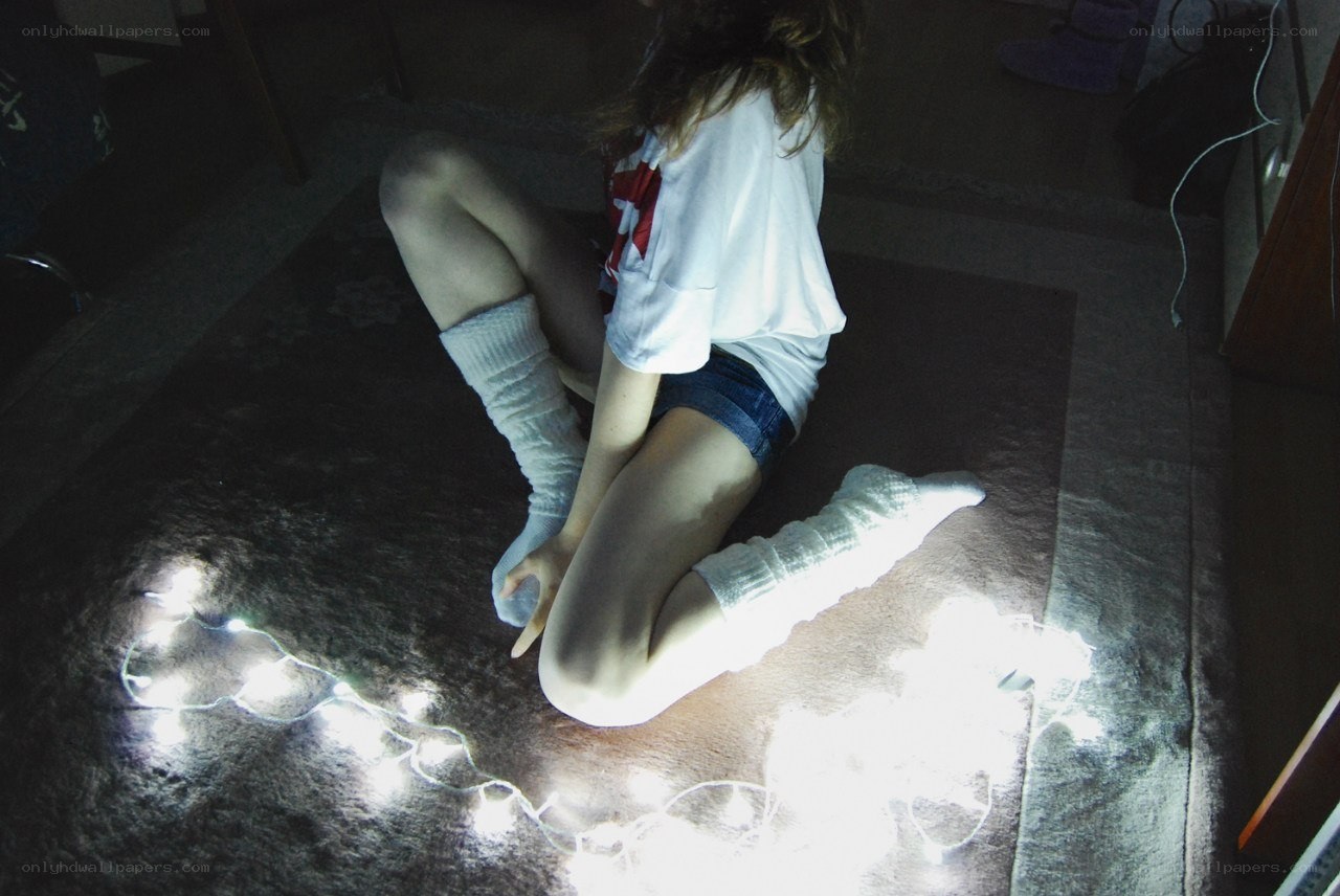 person sitting on floor with lights