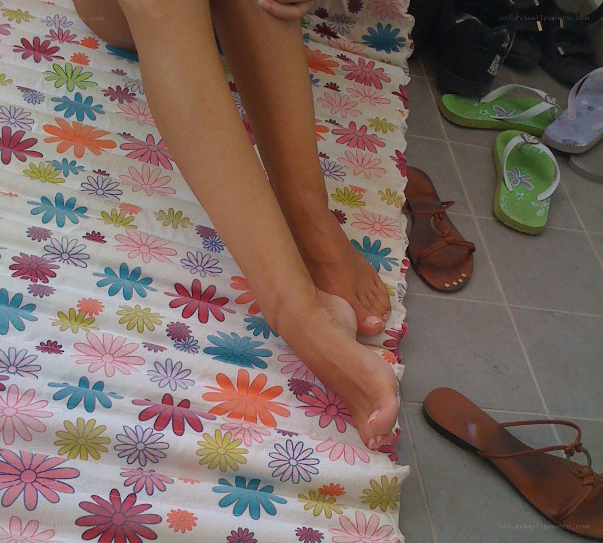 person sitting on floral mat