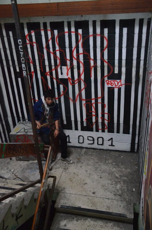 person sitting on graffiti-covered stairs