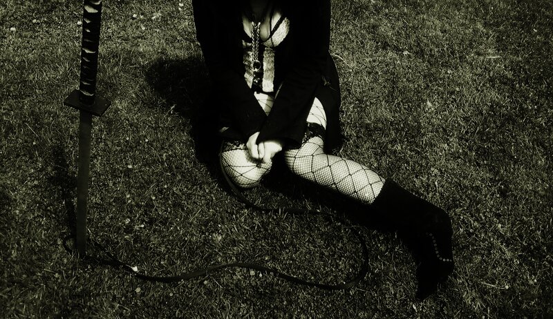 Person Sitting on Grass — Black
