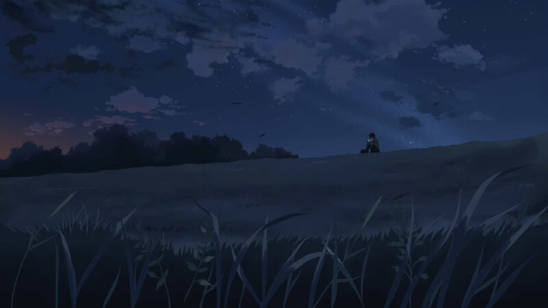 person sitting on hill at night