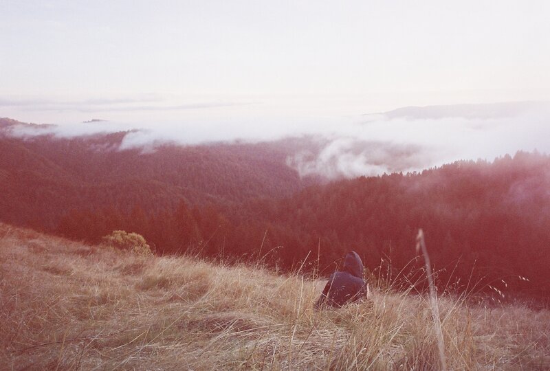 Person Sitting on Hillside