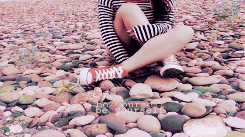 Person Sitting on Pebbles