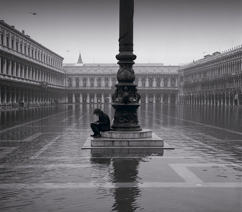 Person Sitting on Pedestal