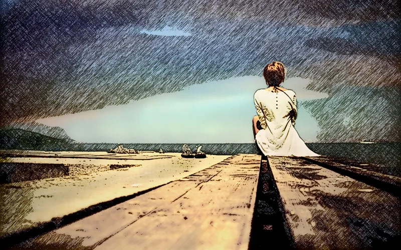person sitting on pier at beach