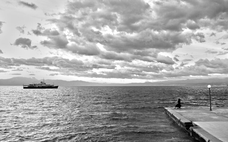 Person Sitting on Pier