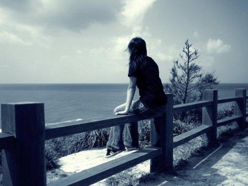Person Sitting on Railing
