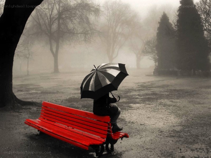 person sitting on red bench