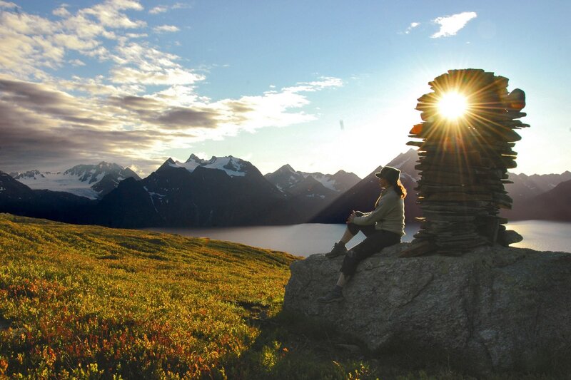 Person Sitting on Rock — Green