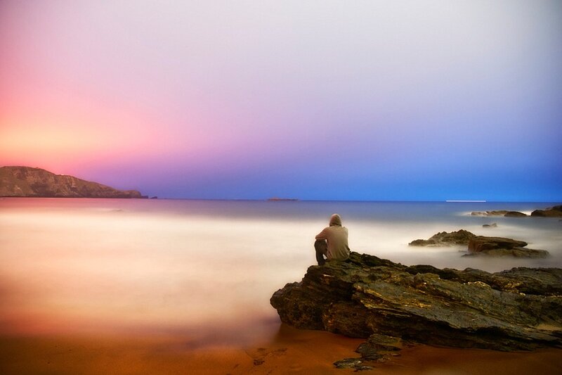 Person Sitting on Rock — Purple