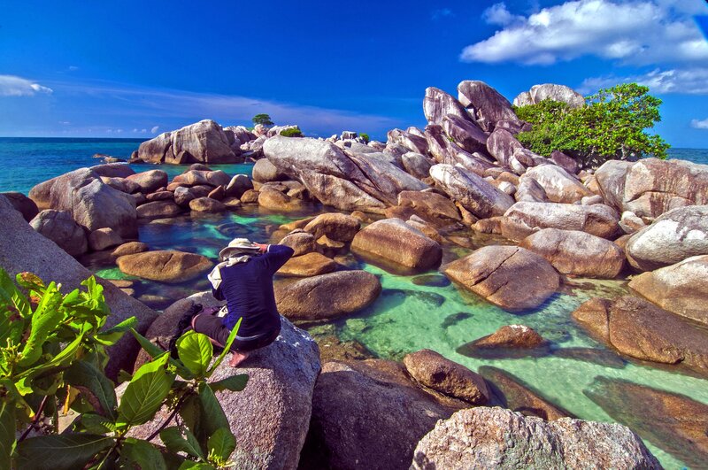 Person Sitting on Rocks