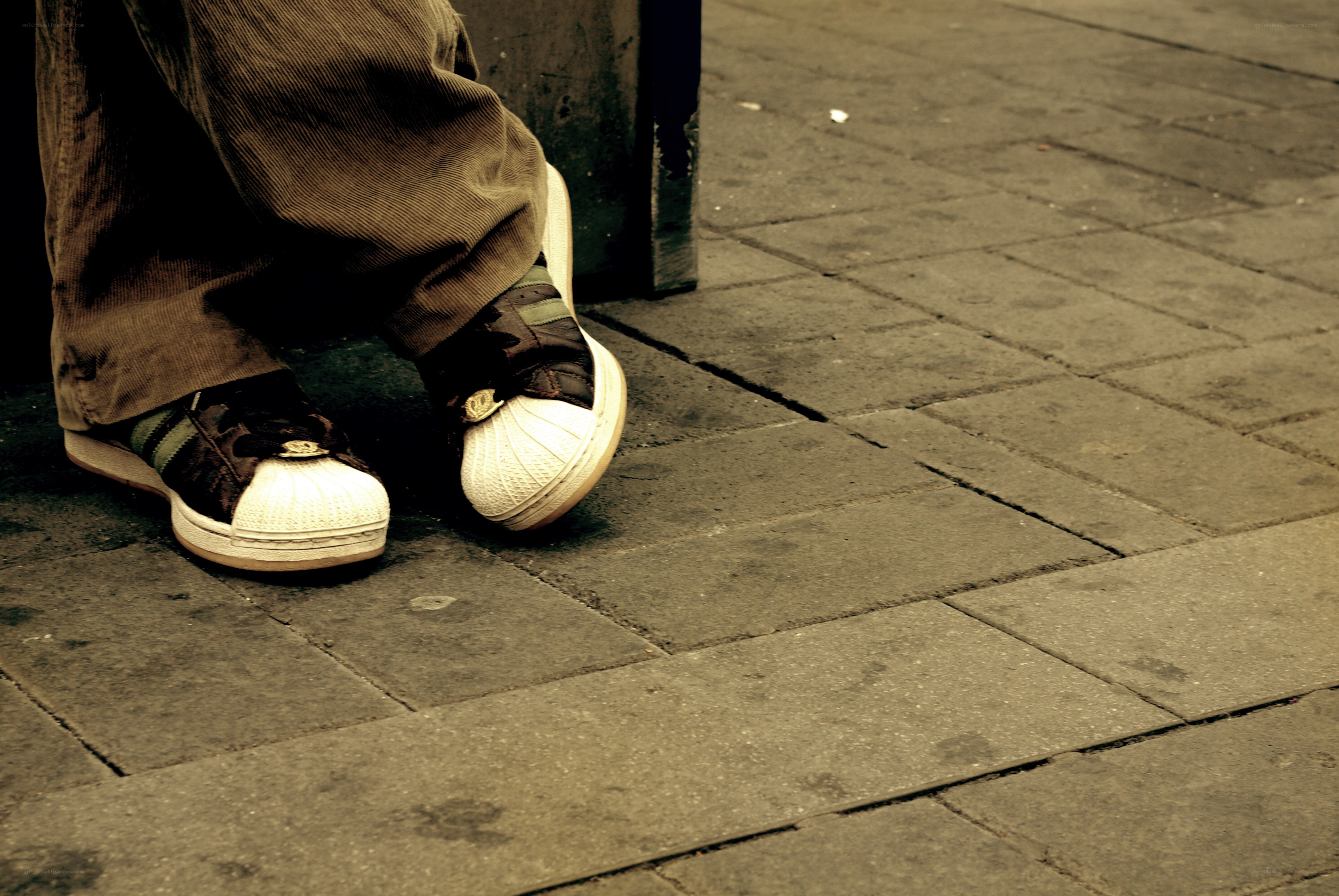 person sitting on sidewalk