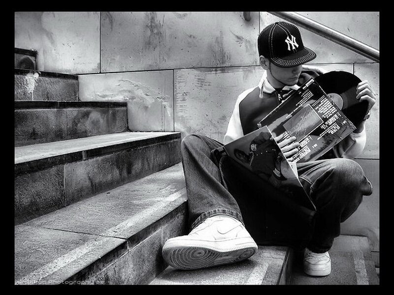 person sitting on stairs with record