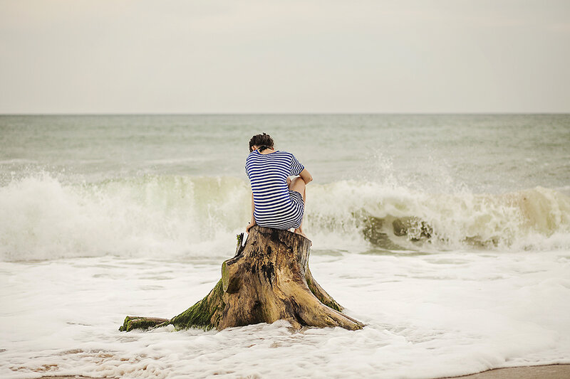 Person Sitting on Tree Stump