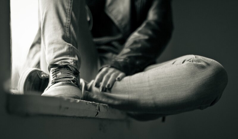 Person Sitting on Window Sill