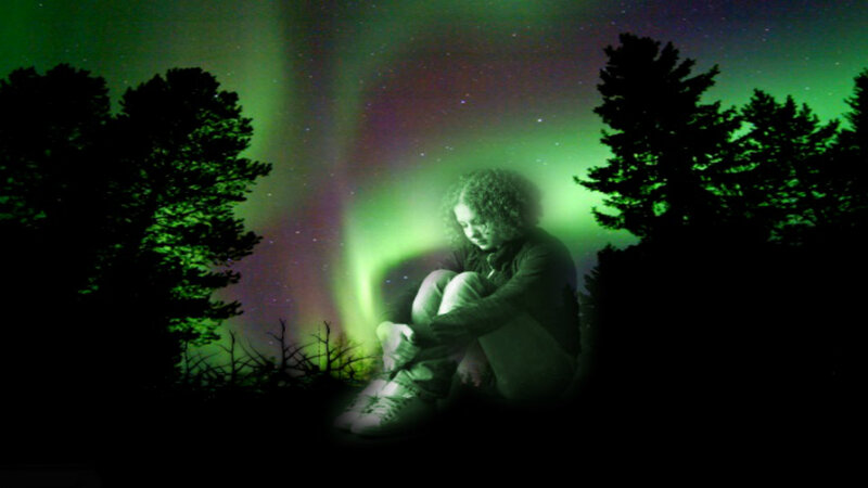 Person Sitting under Aurora