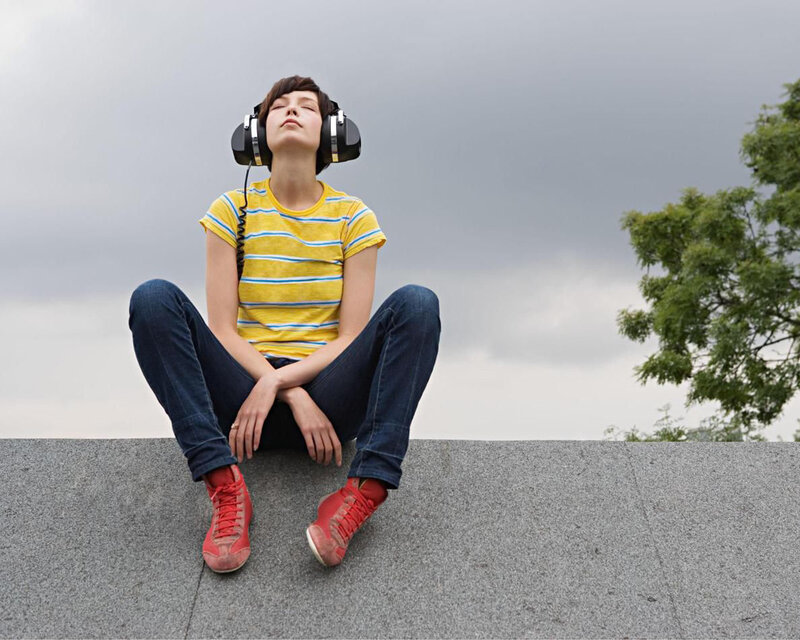 Person Sitting with Headphones
