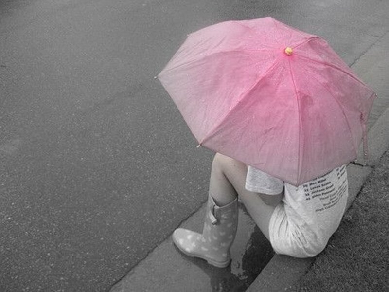 Person Sitting with Umbrella