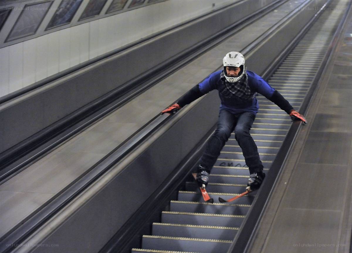 Person skiing on escalator
