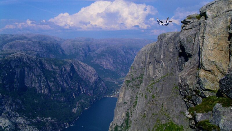 person skydiving over fjord