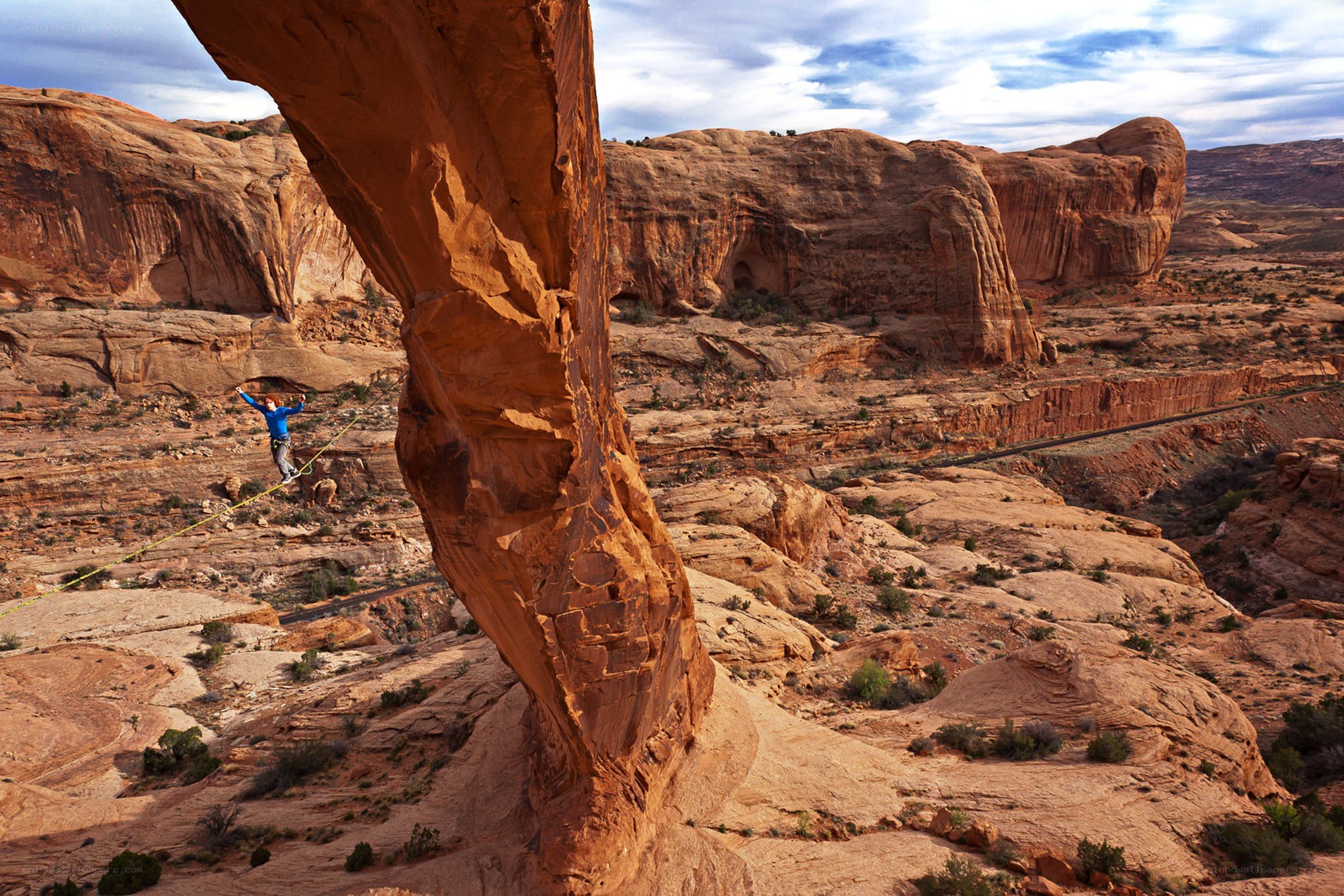 person slacklining in desert canyon