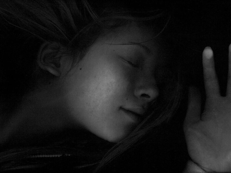 person sleeping in darkness