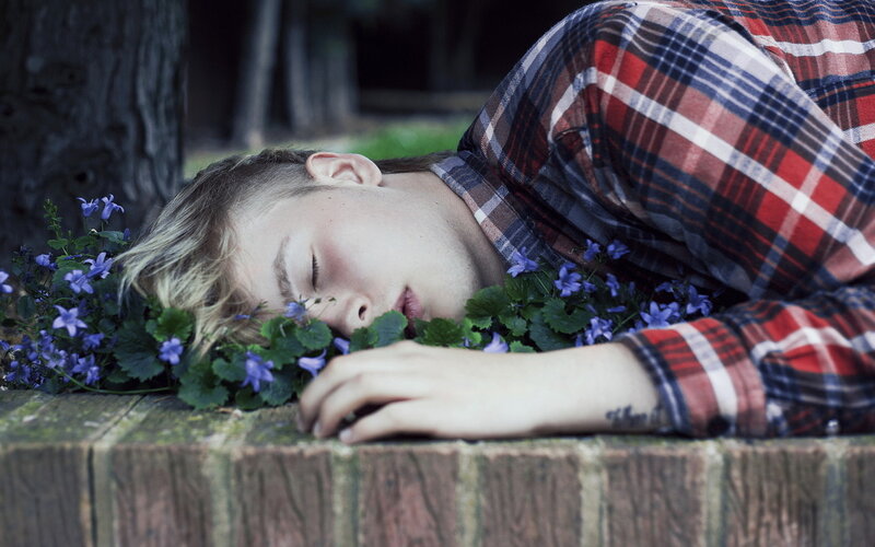 Person Sleeping on Flowers