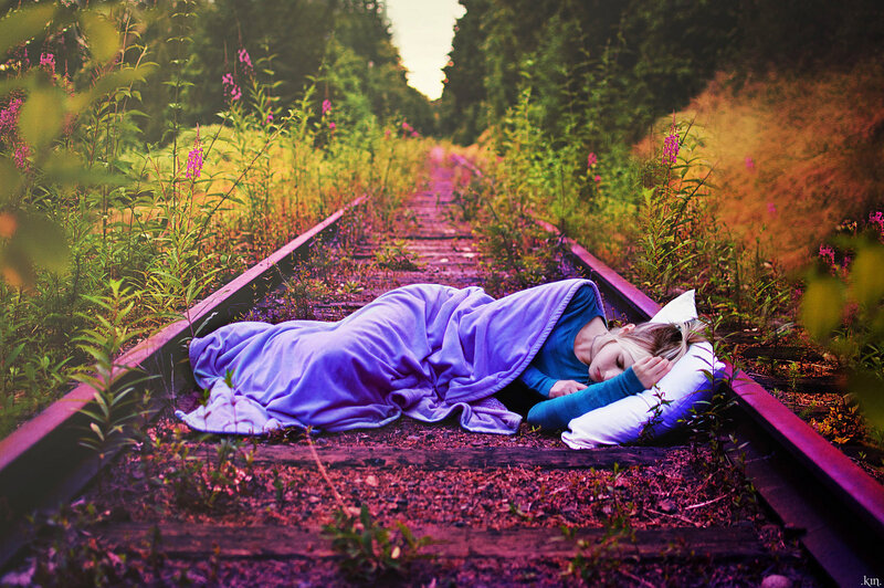 Person Sleeping on Train Tracks — Purple