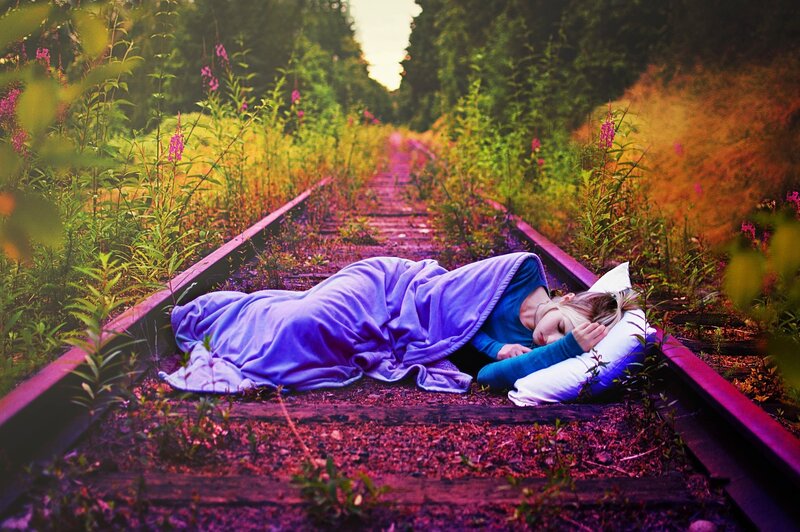 Person sleeping on train tracks