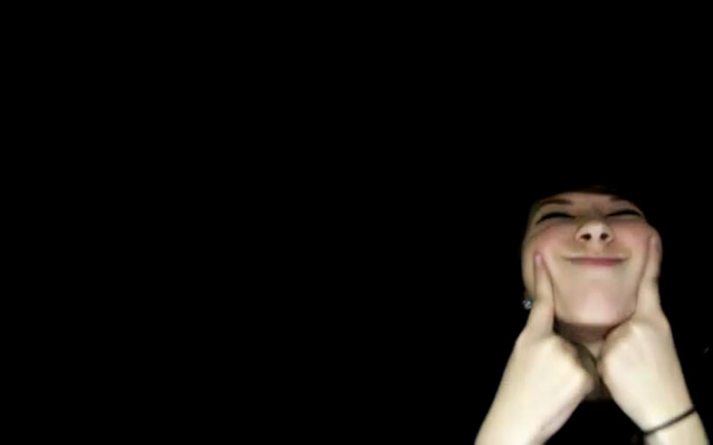 person smiling in dark