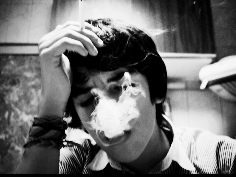 person smoking in black and white