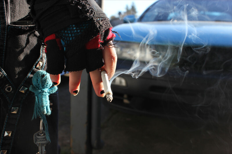 person smoking near car