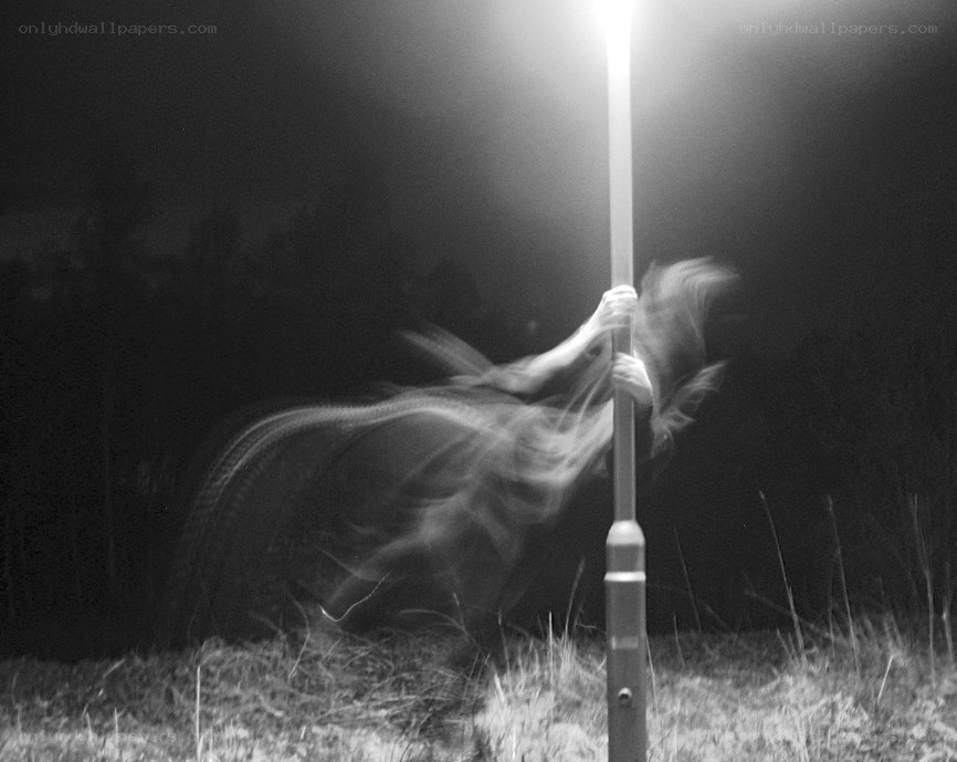 person spinning under streetlight
