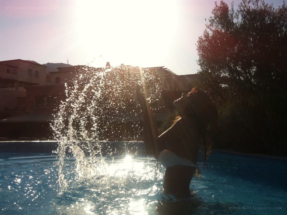 person splashing water in pool