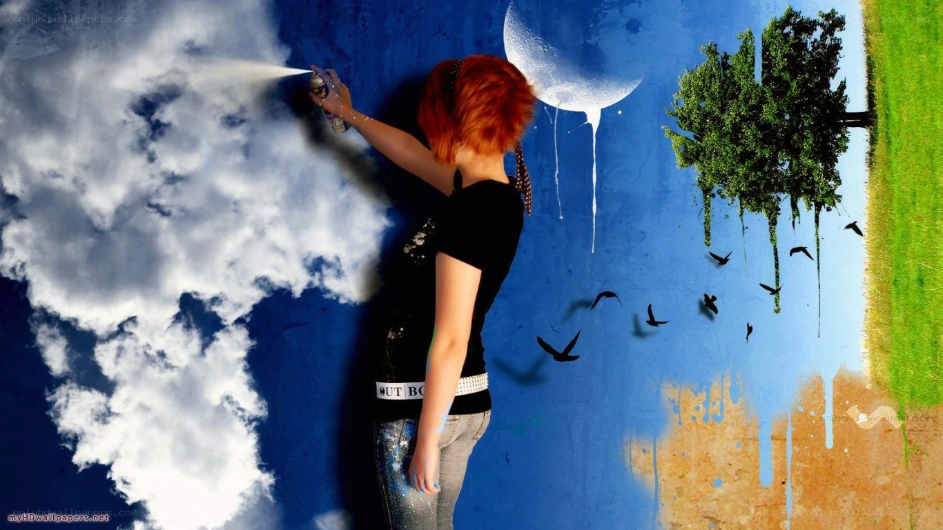 person spray painting a mural