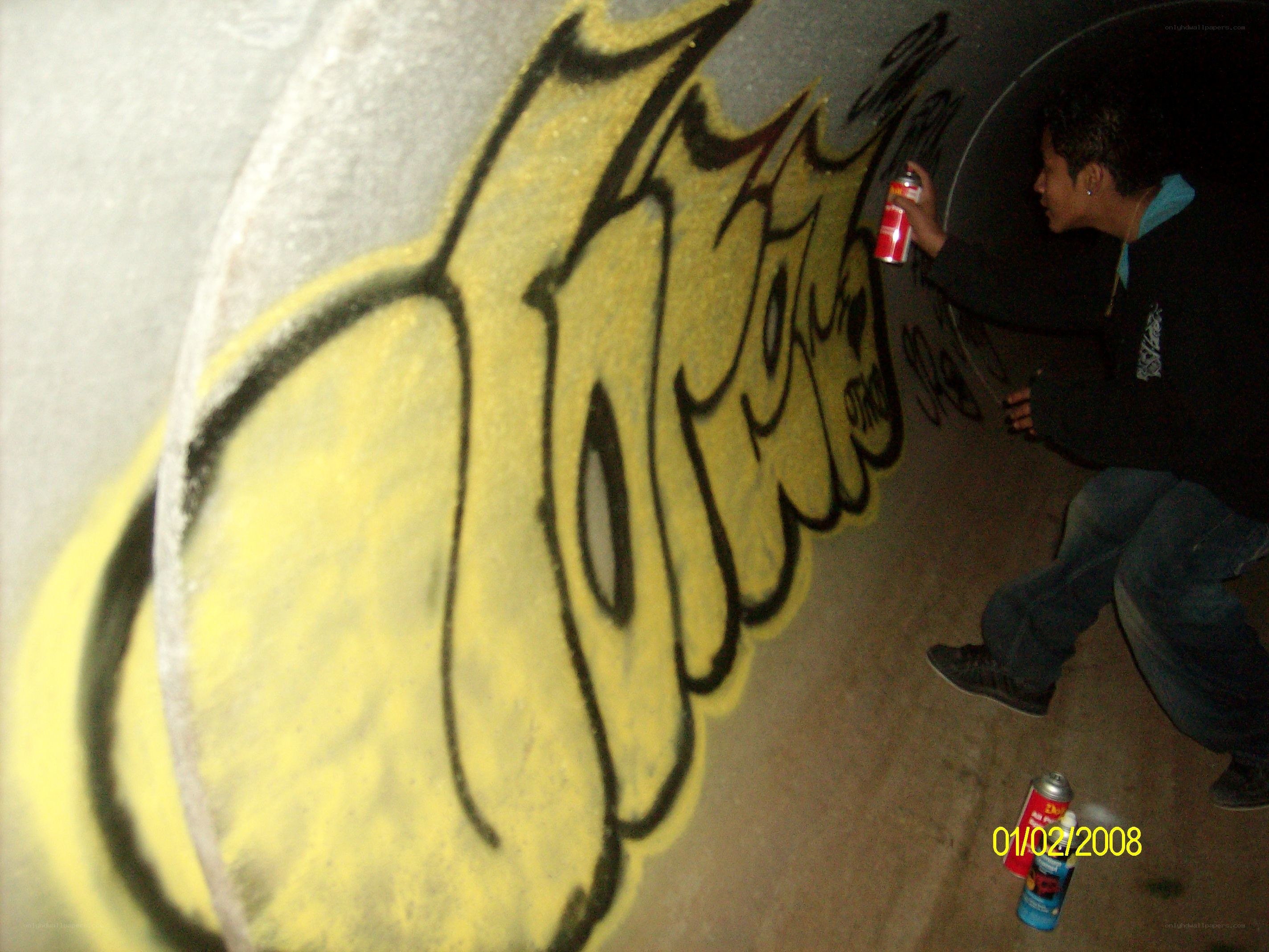 person spray painting graffiti