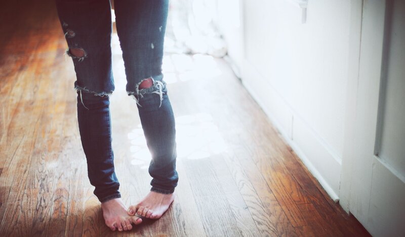 person standing barefoot on wood