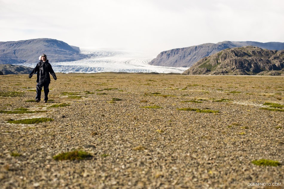 Person standing before a glacier