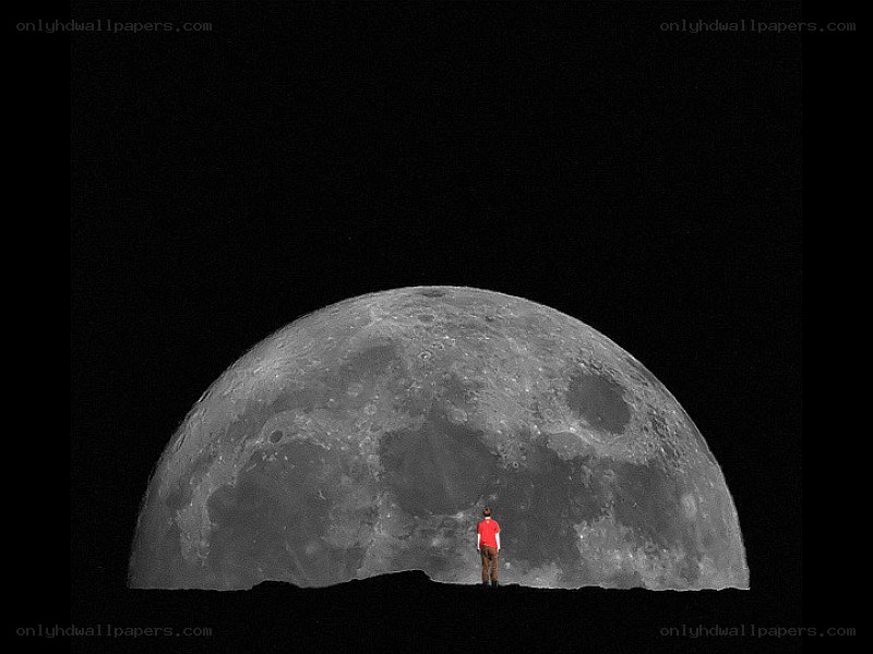 Person standing before a large moon