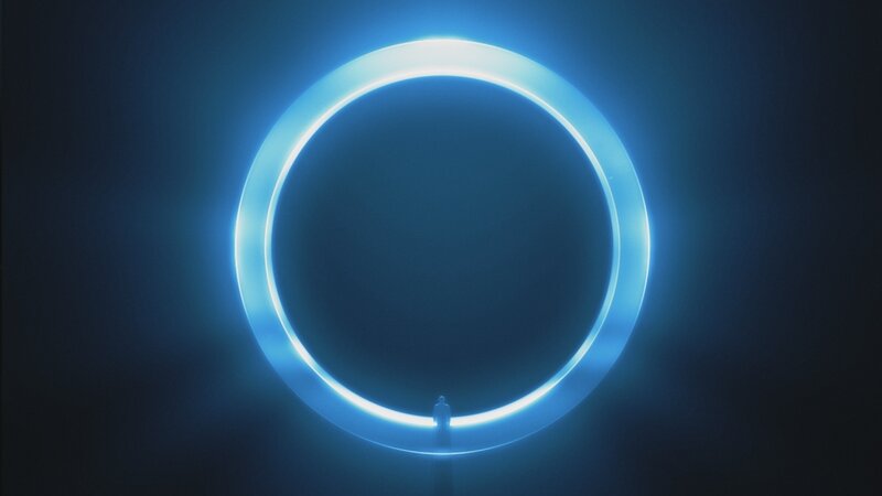 Person Standing Before Glowing Ring