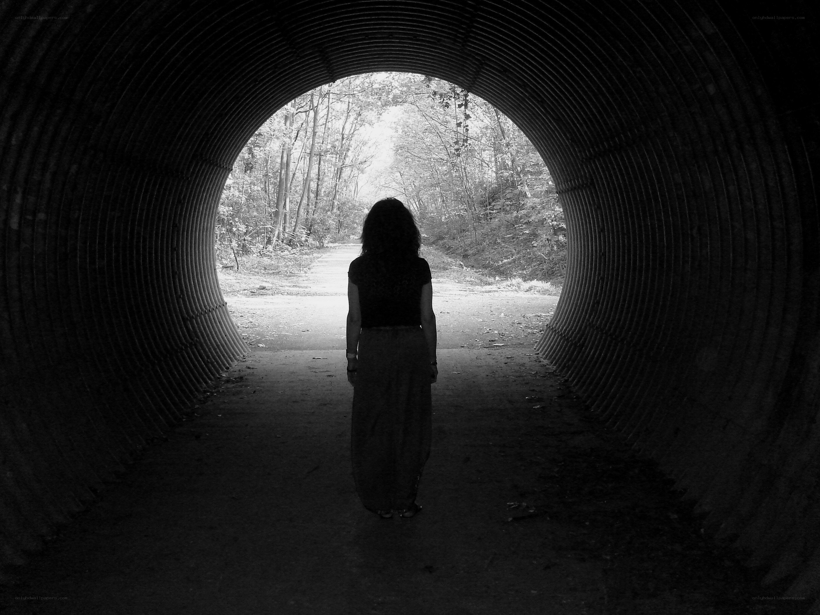 Person standing in a tunnel