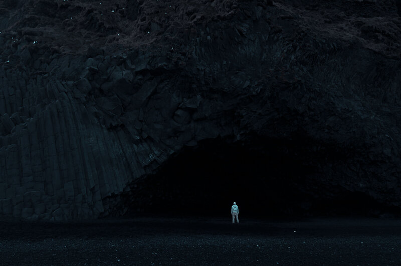 Person Standing in Cave — Black