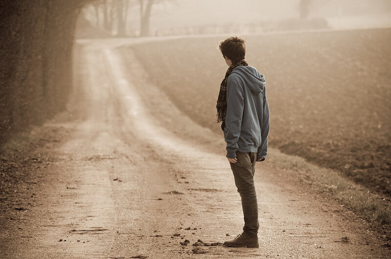 person standing on a dirt road