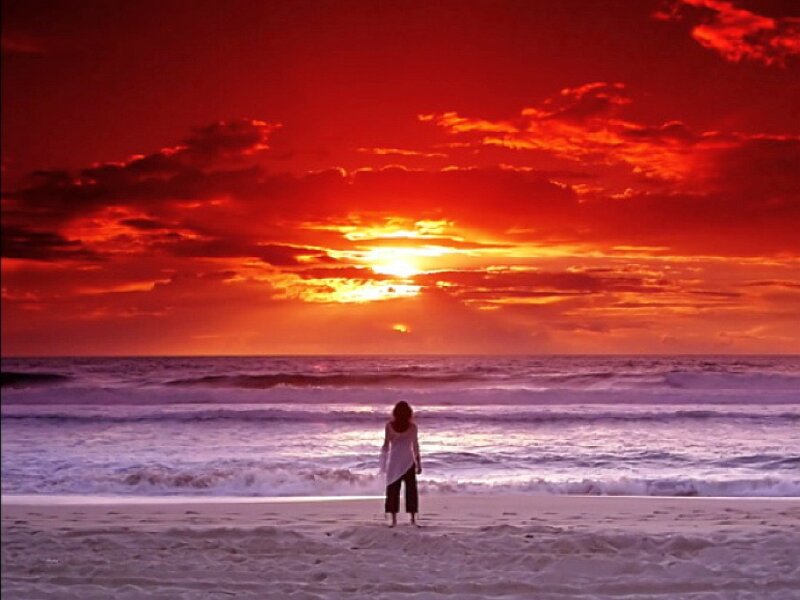 Person Standing on Beach — Red