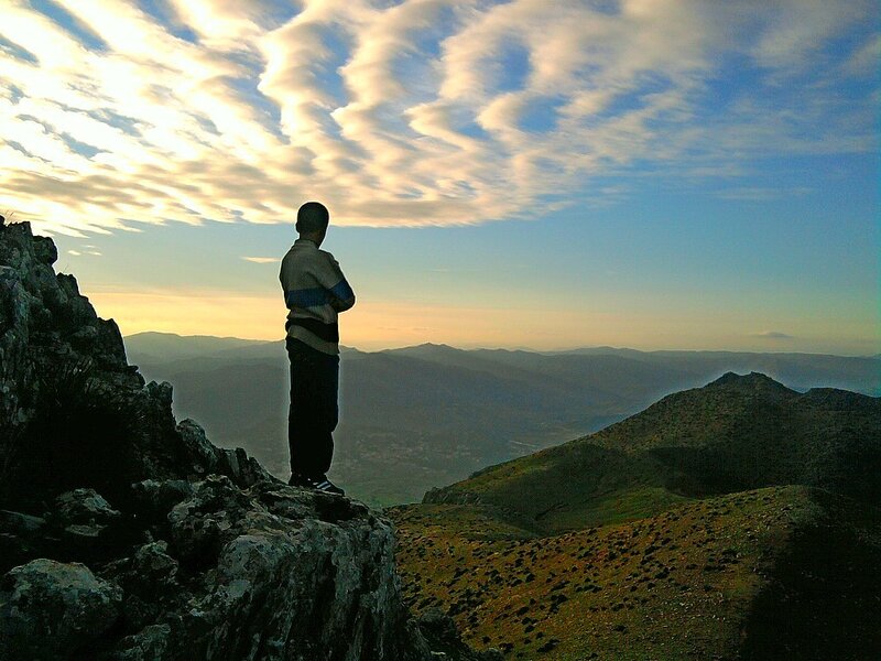 Person Standing on Mountain