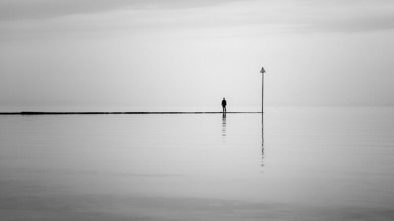 Person Standing on Pier