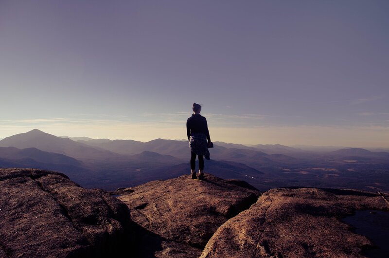Person Standing on Rock — Purple