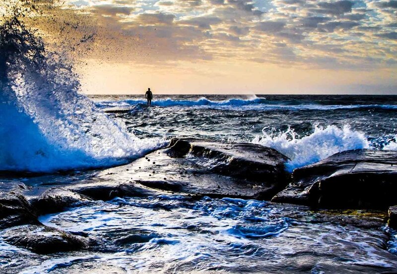 Person Standing on Rocks — Blue, Dramatic