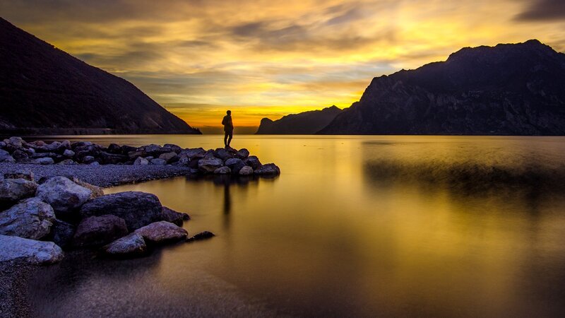 Person Standing on Rocks — Yellow