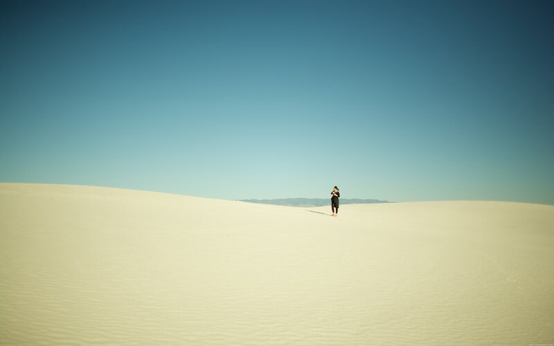 Person Standing on Sand Dune